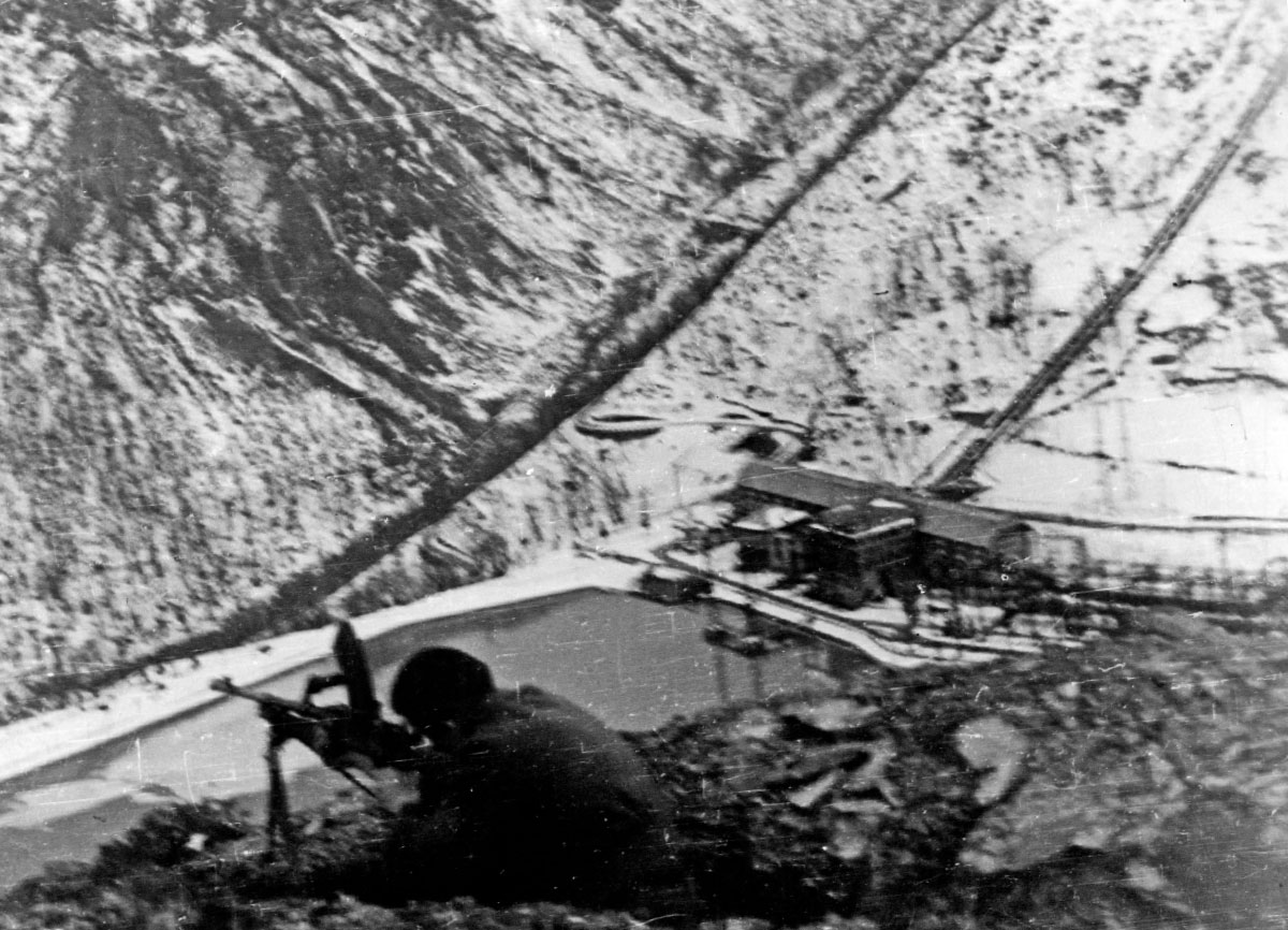 Ein Partisan der 145. Brigade Garibaldi „Franco Casoli” mit einem Bren-Maschinengewehr auf Wachposten zur Verteidigung des Wasserkraftwerks in Ligonchio, Winter 1945; unbekannter Fotograf, Archiv Anpi in der Fotothek des Istoreco